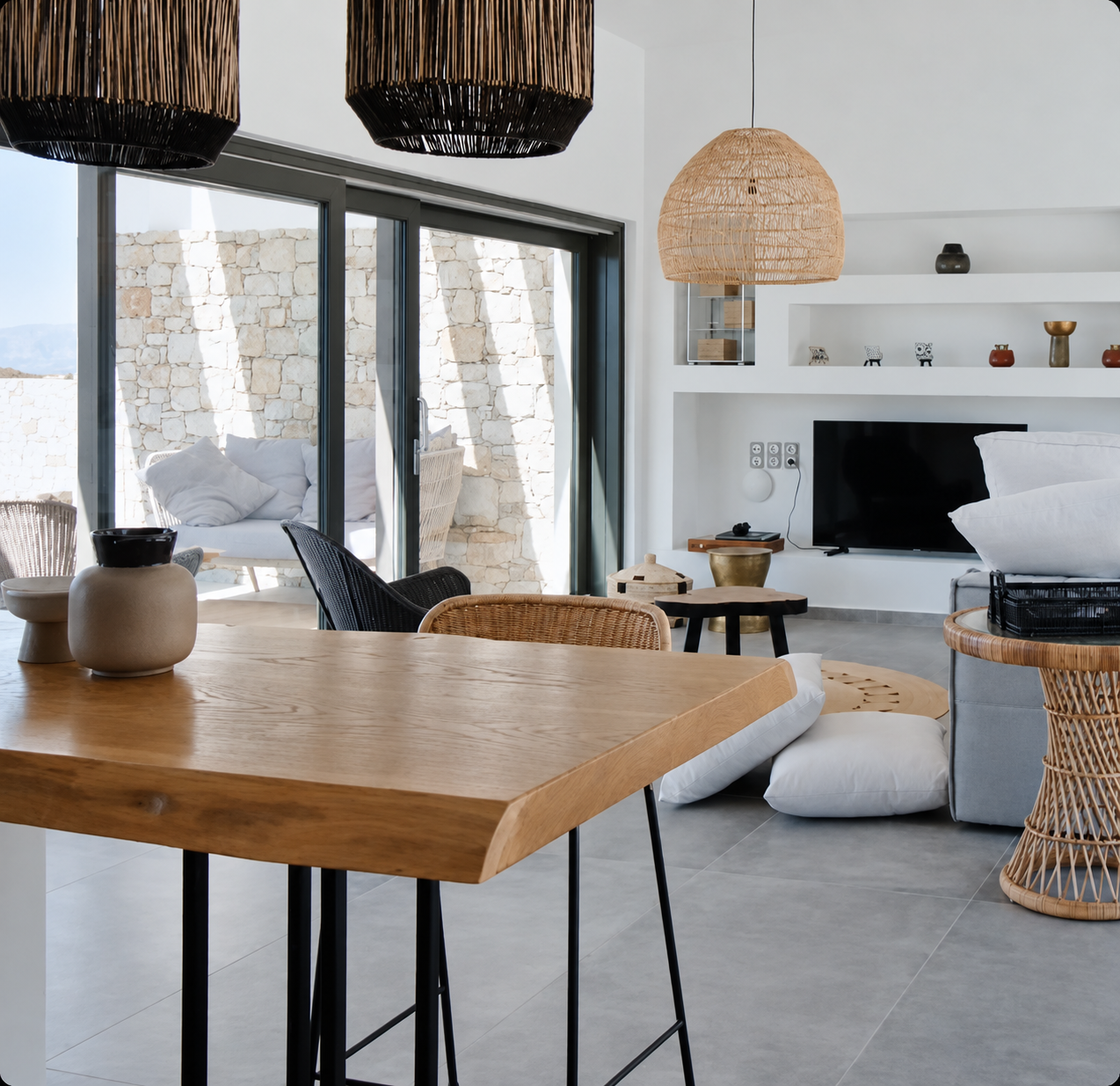 Modern open-plan dining area with timber table and rattan pendant lights